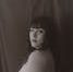 A vintage-inspired sepia portrait of a woman in a classic pose with a soft expression.